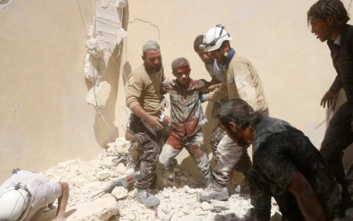 \"103495627_syrian_civil_defence_workers_rescue_a_wounded_young_man_from_under_the_rubble_of_a_col-large_transzgekzx3m936n5bqk4va8rwtt0gk_6efzt336f62ei5u\"